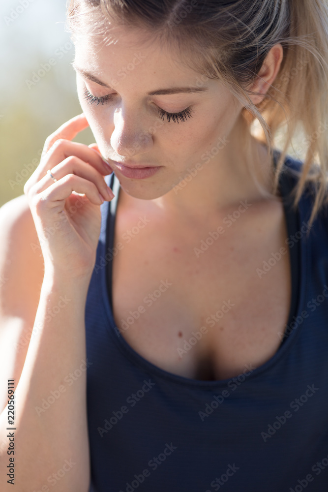 Pretty blonde female athlete touching face Pretty blonde female athlete touching face