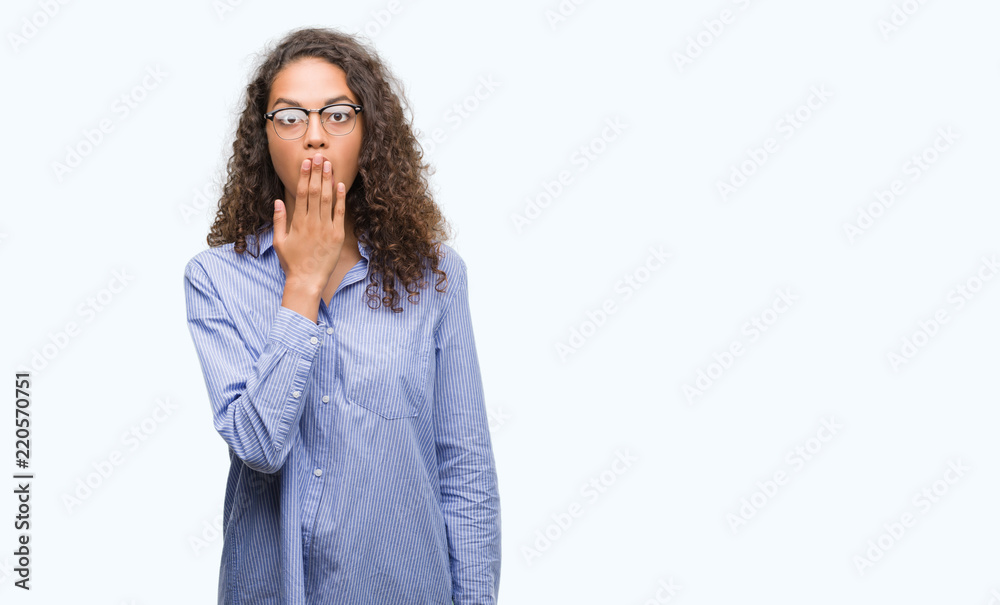 Beautiful young hispanic woman wearing glasses cover mouth with hand shocked with shame for mistake, expression of fear, scared in silence, secret concept Beautiful young hispanic woman wearing glasses cover mouth with hand shocked with shame for mistake, expression of fear, scared in silence, secret concept