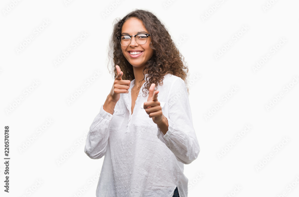 Beautiful young hispanic woman pointing fingers to camera with happy and funny face. Good energy and vibes. Beautiful young hispanic woman pointing fingers to camera with happy and funny face. Good energy and vibes.
