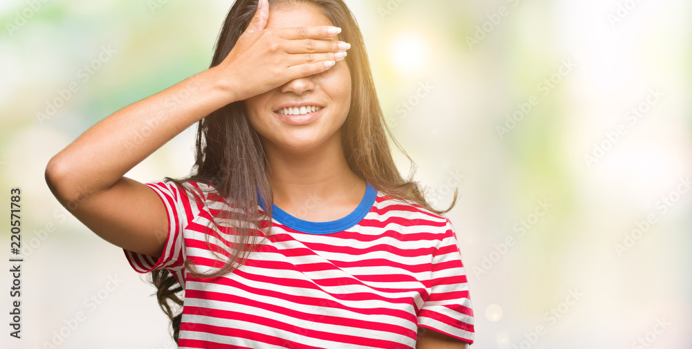 Young beautiful arab woman over isolated background smiling and laughing with hand on face covering eyes for surprise. Blind concept.