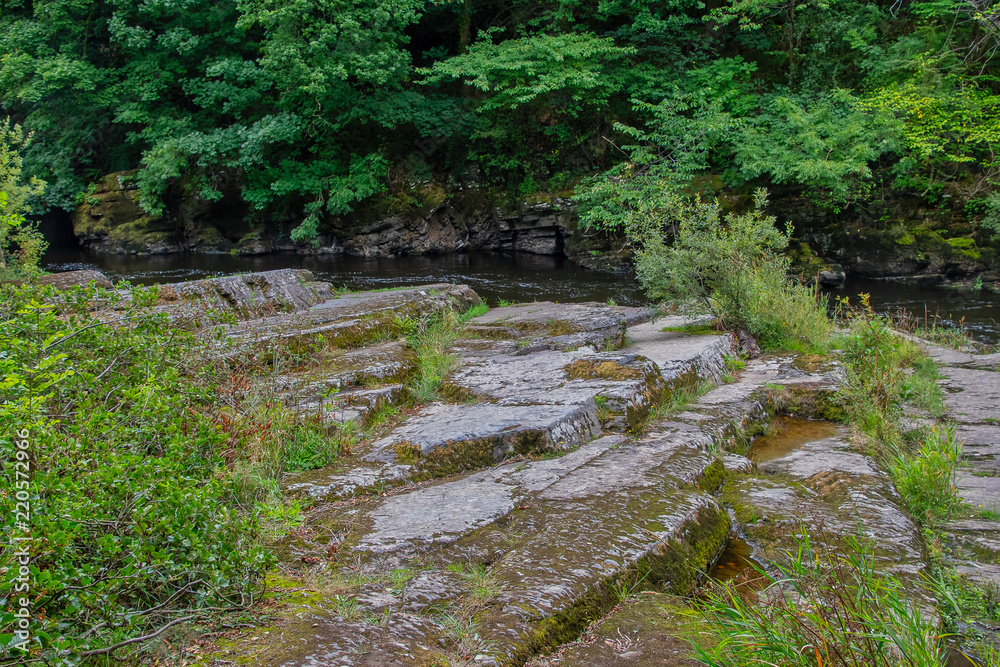 Naklejka premium Slate rocks alongside the river Dee in North Wales