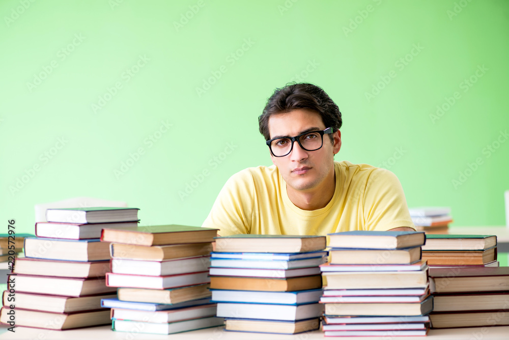 Student with too many books to read before exam Student with too many books to read before exam