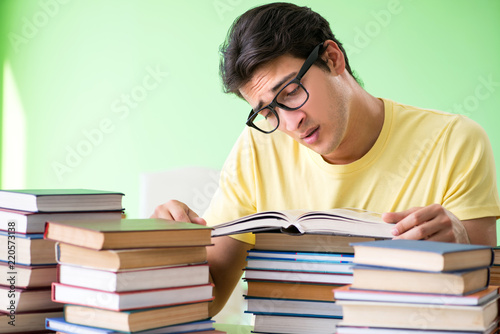 Student with too many books to read before exam