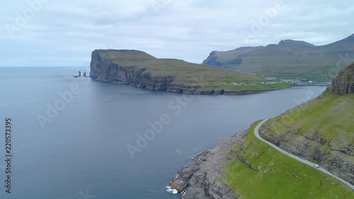 AERIAL: Flying over the calm ocean and towards spectacular cliffs and village.