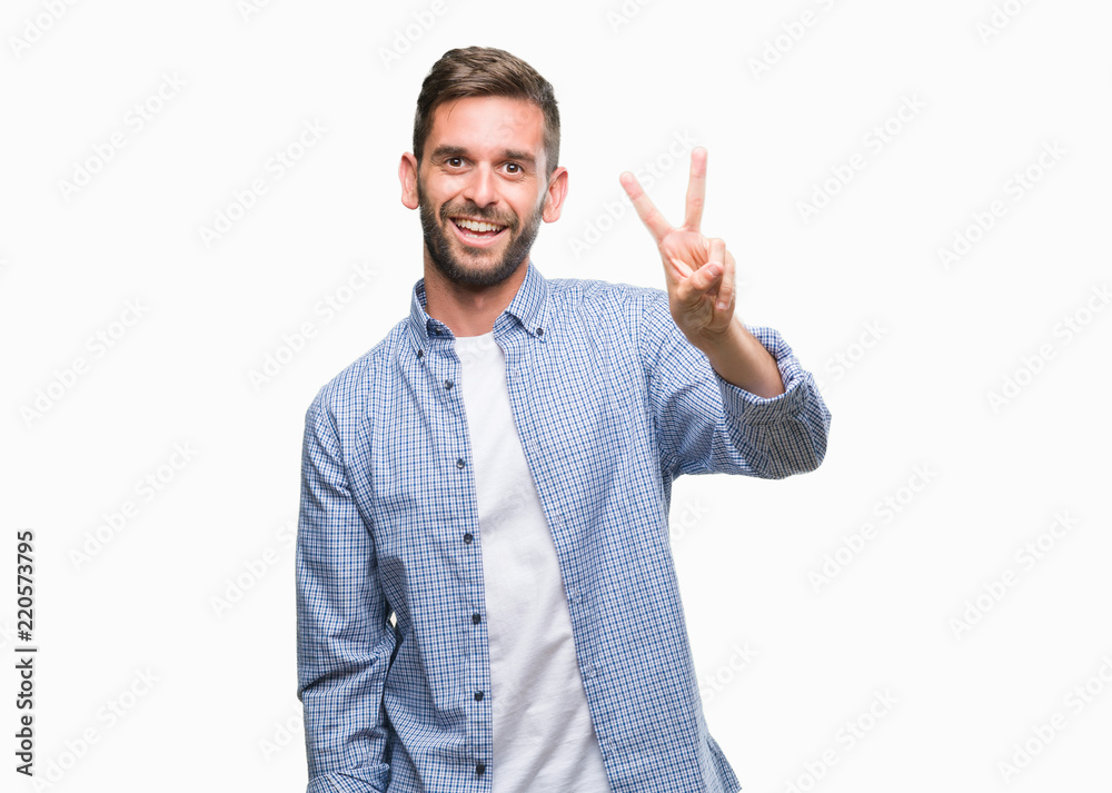 Young handsome man wearing white t-shirt over isolated background smiling looking to the camera showing fingers doing victory sign. Number two. Young handsome man wearing white t-shirt over isolated background smiling looking to the camera showing fingers doing victory sign. Number two.
