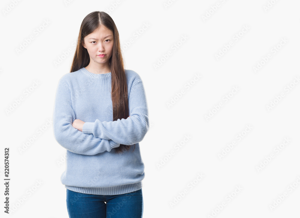 Young Chinese woman over isolated background skeptic and nervous, disapproving expression on face with crossed arms. Negative person. Young Chinese woman over isolated background skeptic and nervous, disapproving expression on face with crossed arms. Negative person.