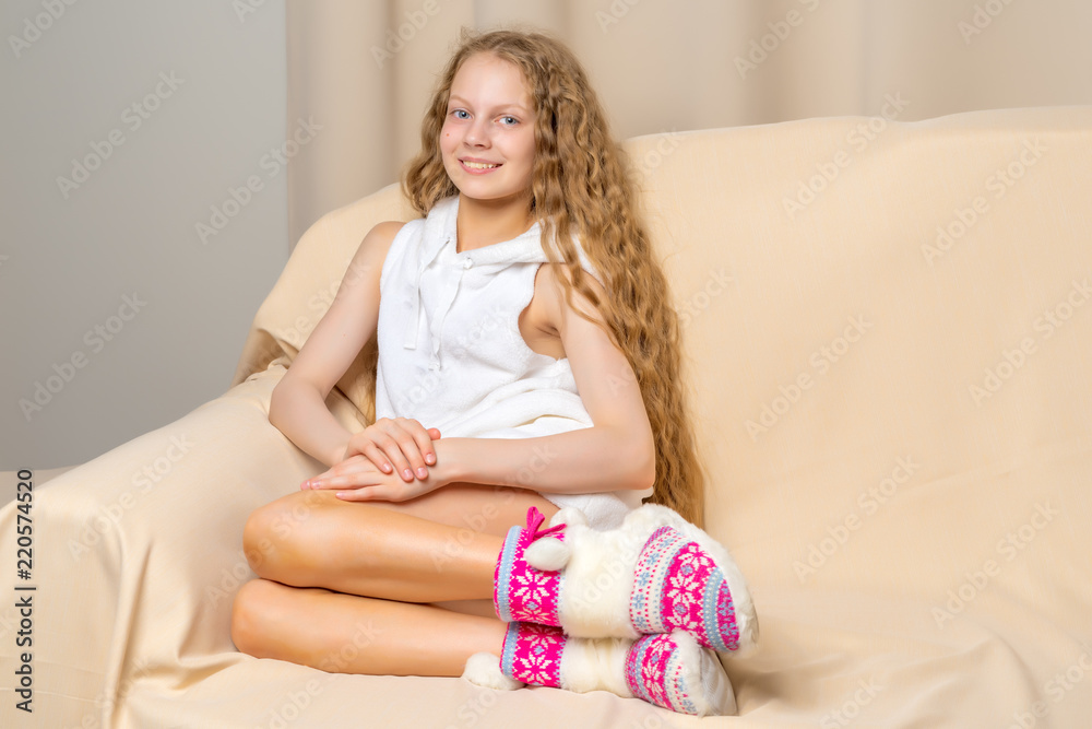 Little girl is sitting on the couch Little girl is sitting on the couch