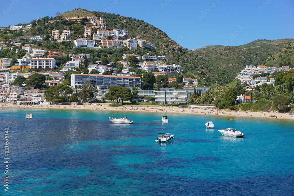 Spain Costa Brava coastal town with sandy beach and boats anchored near the shore, Mediterranean sea, playa Almadrava, Canyelles Grosses, Roses, Girona, Catalonia