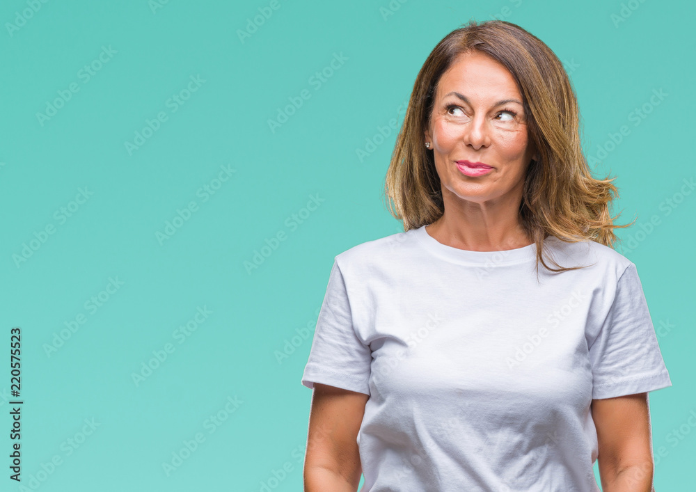 Middle age senior hispanic woman over isolated background smiling looking side and staring away thinking. Middle age senior hispanic woman over isolated background smiling looking side and staring away thinking.
