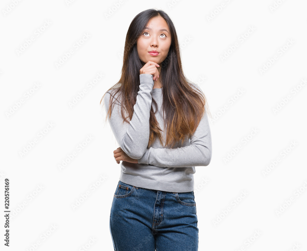 Young asian woman over isolated background with hand on chin thinking about question, pensive expression. Smiling with thoughtful face. Doubt concept. Young asian woman over isolated background with hand on chin thinking about question, pensive expression. Smiling with thoughtful face. Doubt concept.