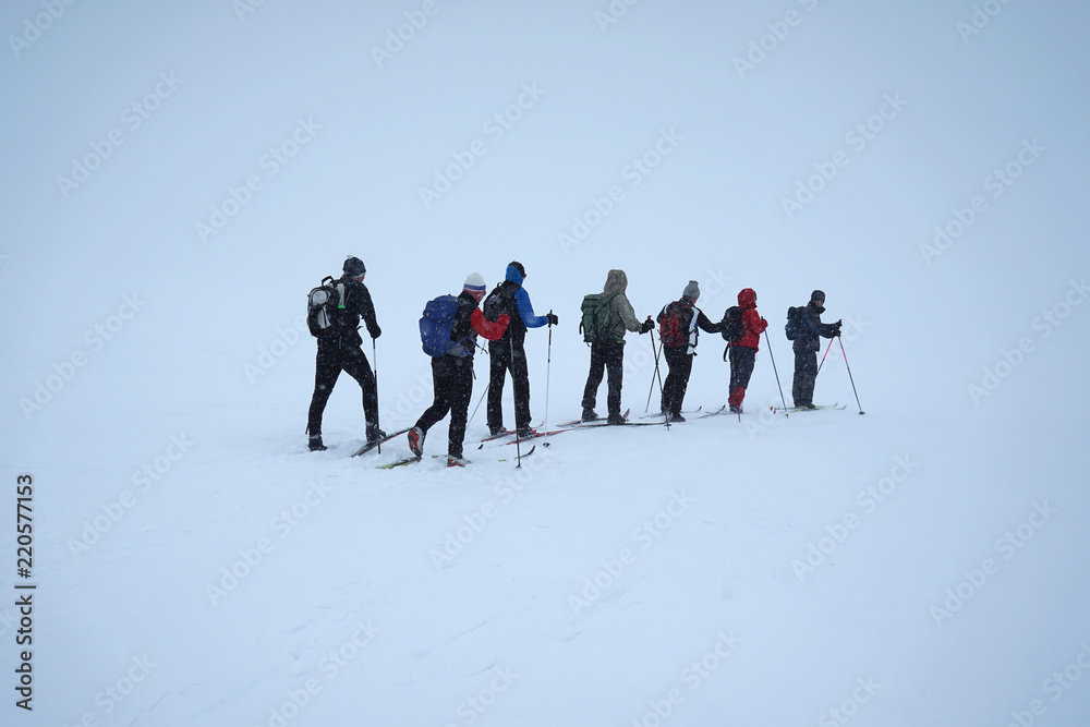 Team of people, old friends skiing.