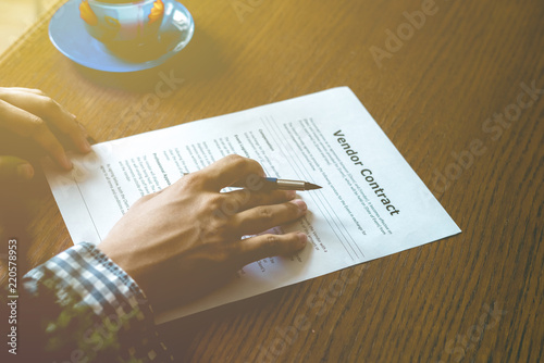 close up hand sign vendor contract on table for the new house, concept photo