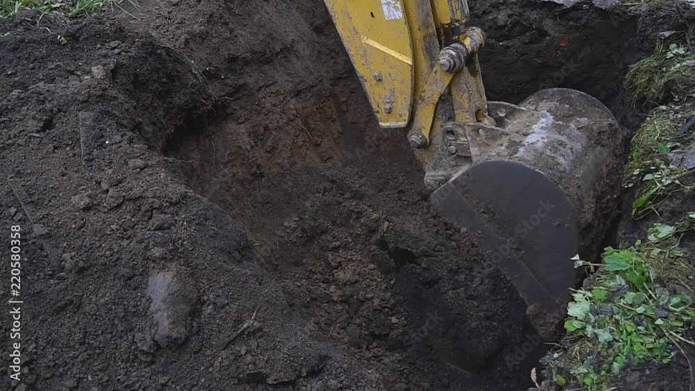 Excavator shovel digging a deep hole Excavator shovel digging a deep hole