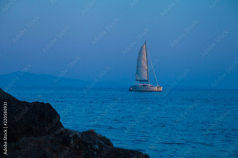 Catamaran at sea during blue hour