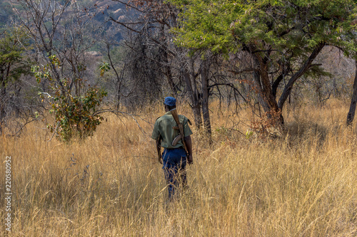 Park scout armed with AK-47 as an anti poaching measure to ensure wildlife safety, Matopos, Zimbabwe © Gonçalo