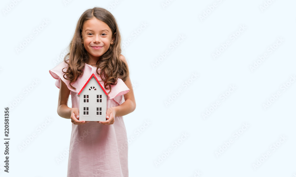 Brunette hispanic girl holding little house with a happy face standing and smiling with a confident smile showing teeth Brunette hispanic girl holding little house with a happy face standing and smiling with a confident smile showing teeth
