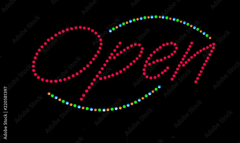 Colorful, bright beaded lights OPEN sign on black background.