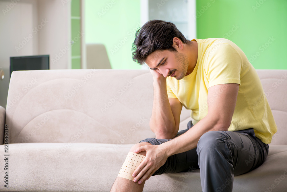 Man applying pepper Capsicum plaster to relieve pain Man applying pepper Capsicum plaster to relieve pain