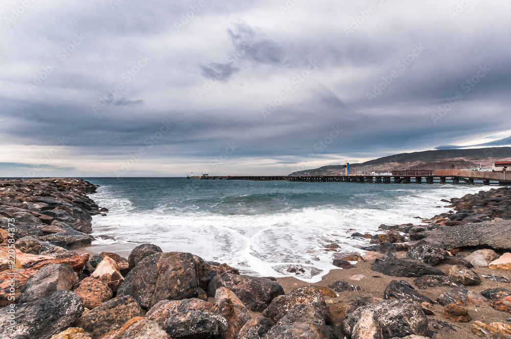 Beach landscape and rocks with cloudy sky