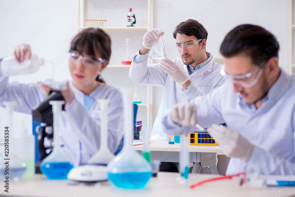 Team of chemists working in the lab Team of chemists working in the lab