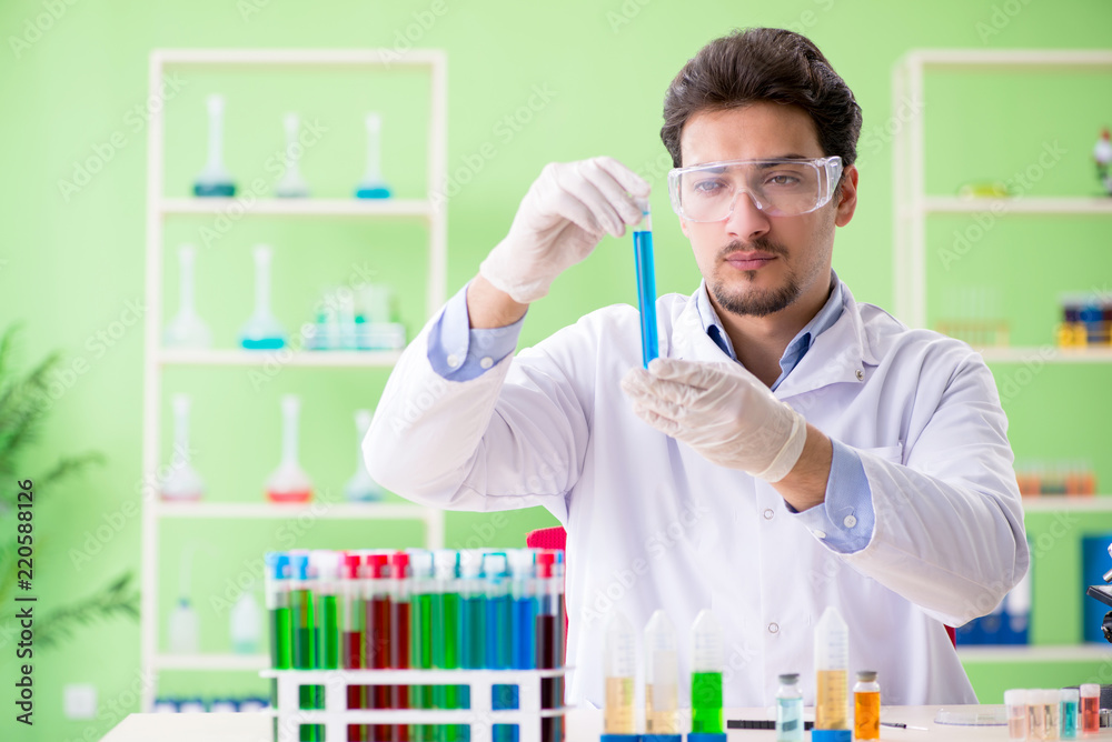 Man chemist working in the lab Man chemist working in the lab