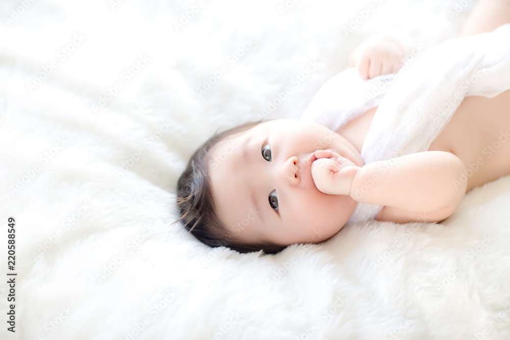 Lovely baby putting his hands in his mouth. image for background