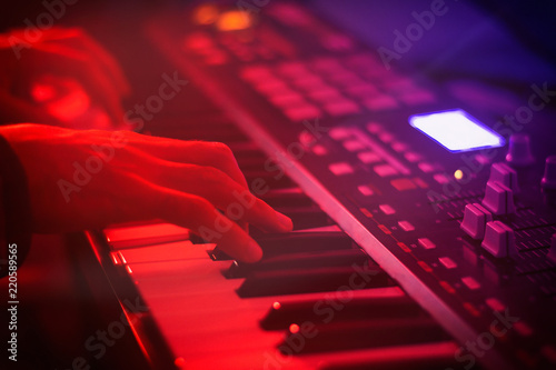 Keyboardist hands playing on synthesizer photo