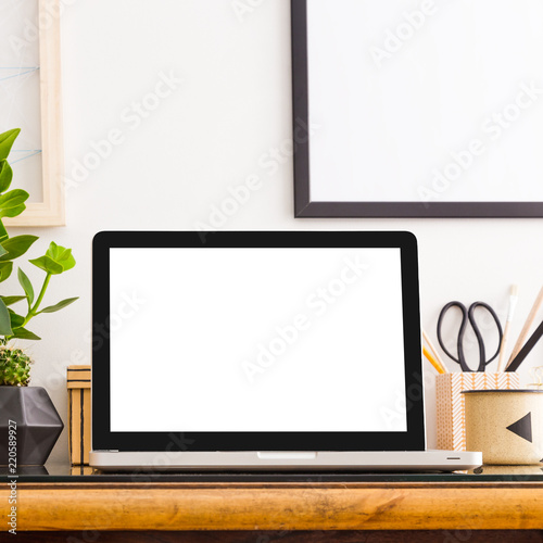 Home office interior design wooden desk with laptop mock up, frame, plants in design pots, vinatage camera. photo