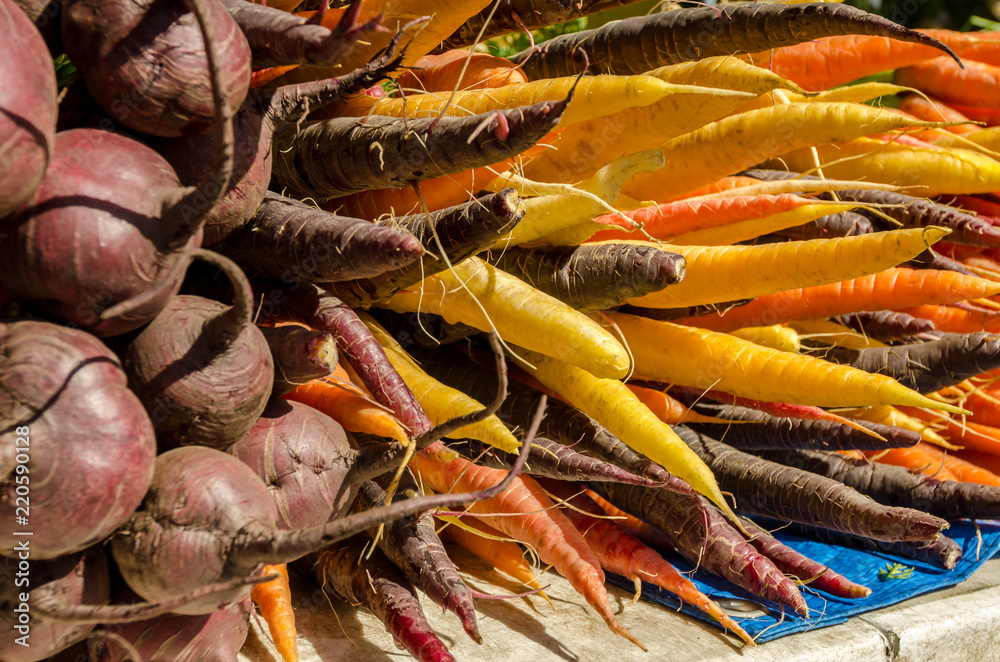 Beetroot and multi-coloured carrots on a market stall in Hobart, Tasmania, Australia.