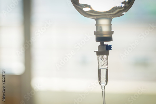 Close up saline bottle and saline drop with blur background. Illness treatment. Health insurance plan. Medical Benefits. Reimbursement. Medical expenses. image for illustration, copy space, article.