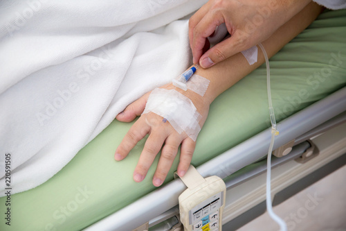 Focus patient's hand has get the saline solution syringe on it. Illness and treatment. Health insurance plan. Reimbursement and Medical expenses. image for illustration, copy space, article.