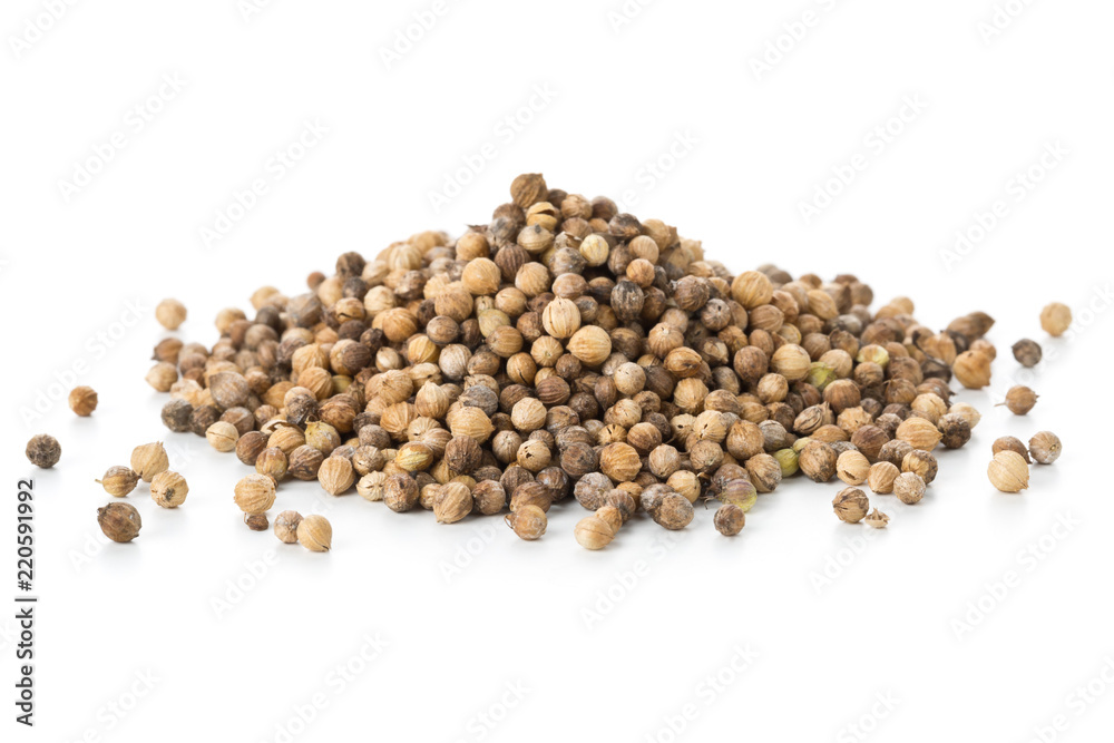 Heap of raw, unprocessed organic coriander or cilantro seeds on white Heap of raw, unprocessed organic coriander or cilantro seeds on white