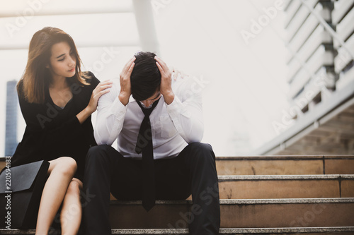 Couple with serious Tired depressed unemployed man sitting in city,Encouragement
 concept.