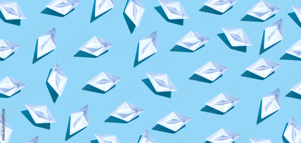 Collection of paper boats on a blue background Collection of paper boats on a blue background