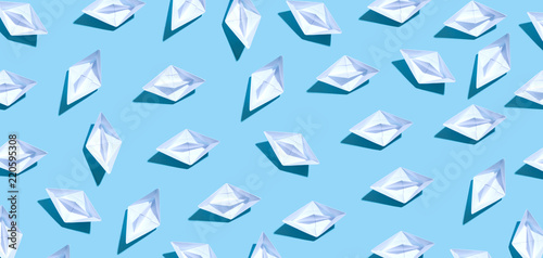 Collection of paper boats on a blue background