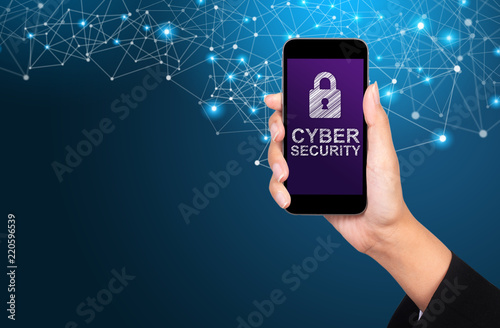 Cyber security concept. Cyber security on smartphone screen in businesswoman hand