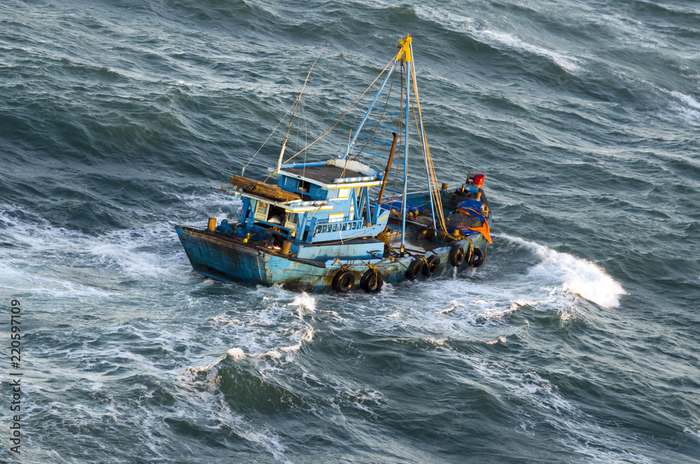 Fishing boat in a stormy sea
