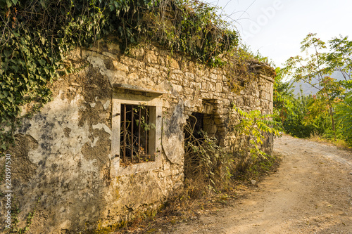 Fototapeta Naklejka Na Ścianę i Meble -  Old abandoned stone-built house in Old Perithia at Pantokrator Mountain, Corfu Island, Greece