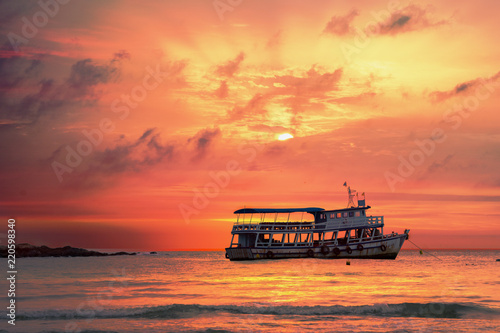 Seascape scenery of sunrise sky with wooden boat at Samed island rayong district Thailand