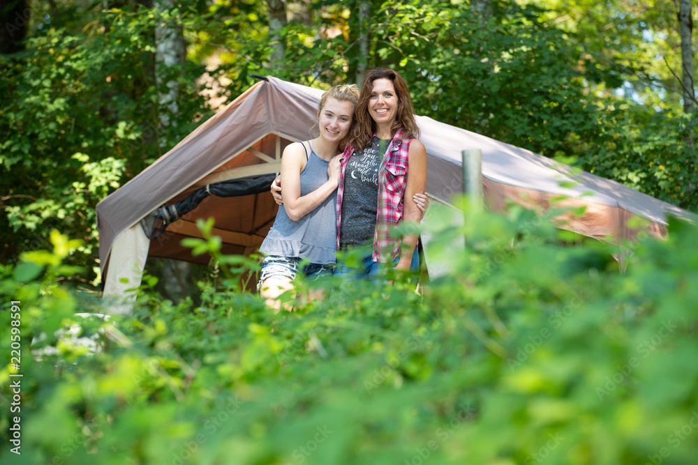 Fototapeta premium Happy mother and daughter camping in nature