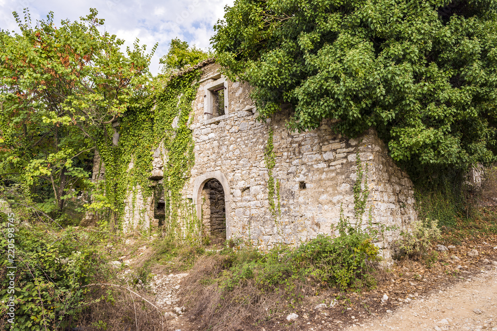 Obraz premium Old abandoned stone-built house in Old Perithia at Pantokrator Mountain, Corfu Island, Greece