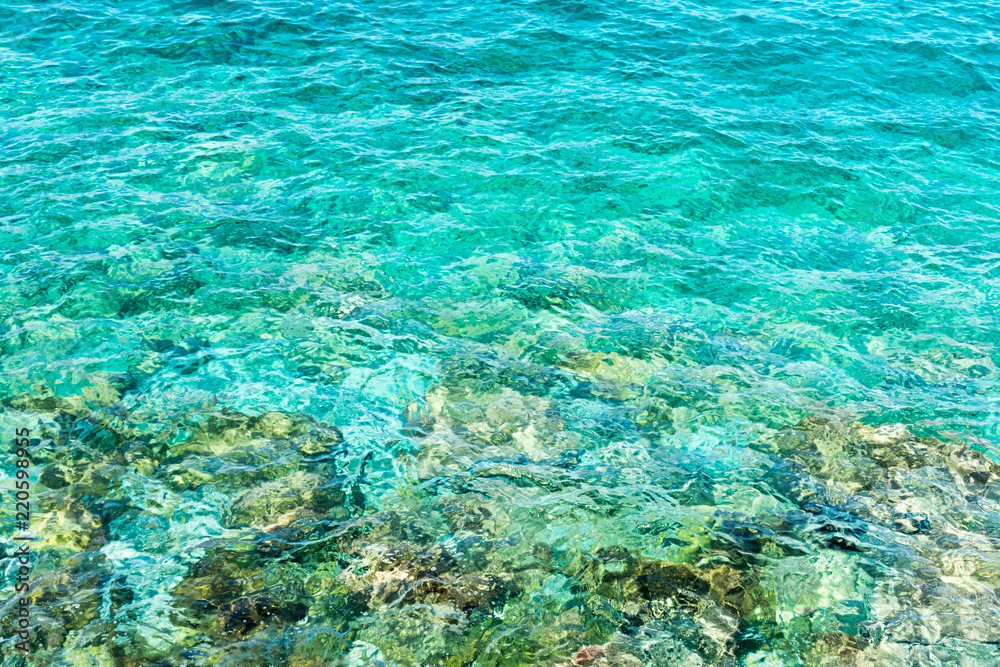 transparent sea surface and rocks on the bottom