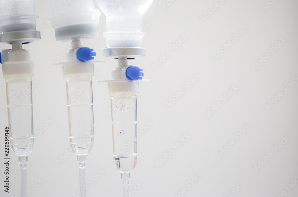 Close up saline bottle and saline drop with blur background. Illness treatment. Health insurance plan. Medical Benefits. Reimbursement. Medical expenses. image for illustration, copy space, article. Close up saline bottle and saline drop with blur background. Illness treatment. Health insurance plan. Medical Benefits. Reimbursement. Medical expenses. image for illustration, copy space, article.