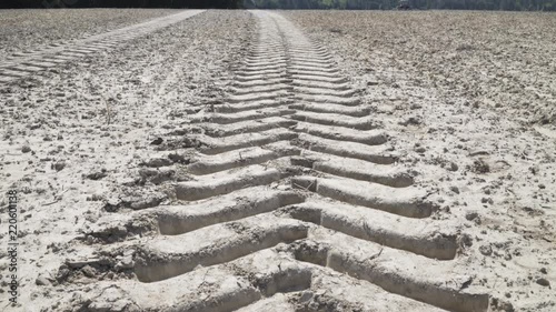 Large tire tracks in dirt field