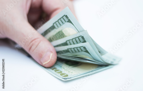 Man counting A Stacks Of Paper Dollars Usa On The White Background