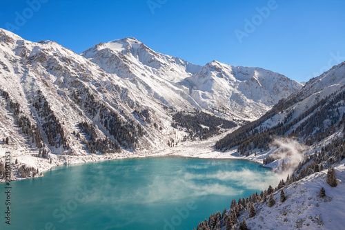 Fototapeta Naklejka Na Ścianę i Meble -  Satpayev peak (4317 m) and emerald Big Almaty Lake at winter season. Tian Shan mountains, Kazakhstan.