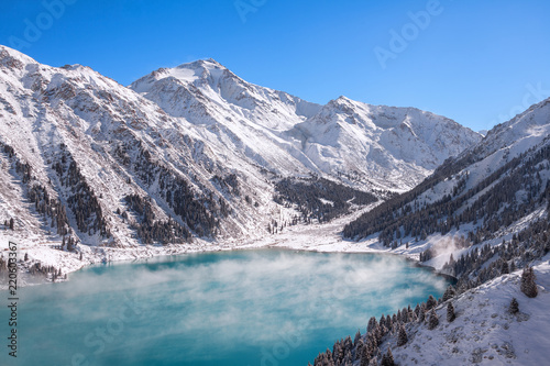 Satpayev peak (4317 m) and emerald Big Almaty Lake at winter season. Tian Shan mountains, Kazakhstan.