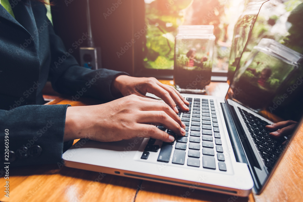 Young businesswoman is working by typing on his computer laptop