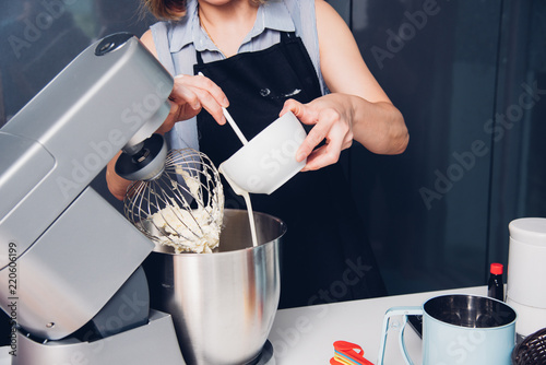 Obraz na plátně Woman making mixer bakery cake machine