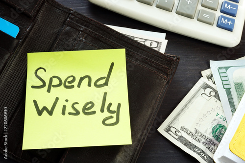 Open wallet with memo spend wisely. Money habits. photo